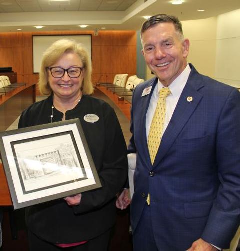 Presidents of two Georgia colleges were surrounded by enthusiastic faculty and staff Thursday as they signed an historic articulation agreement in Columbus.
