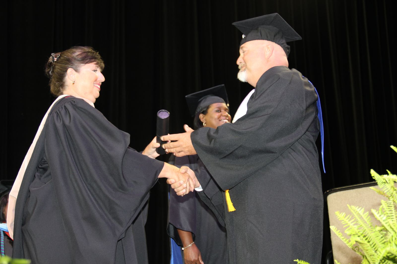 Student and Army Veteran Donald Thrasher accepts his degree from President Hoover